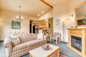 a living room with a couch and a fireplace at Icicle Village Resort 507: Alpenglow Condo in Leavenworth