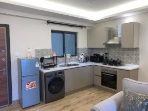 a kitchen with a dishwasher and a washer at 1-BR Gem Near GTC, Westlands 5G in Nairobi