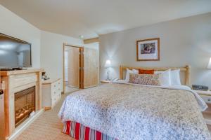 una camera da letto con un letto grande e una televisione di Icicle Village Resort 401 & 402: Ponderosa Hideaway a Leavenworth Altre 30 foto