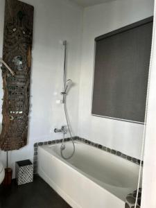 a white bath tub in a bathroom with a window at Cloud 11 Jamaica in Treasure Beach