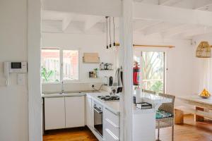 a kitchen with white cabinets and a counter top at 10i Mimosa by African Perfection in Jeffreys Bay
