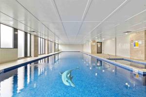 a swimming pool with a dolphin in the middle of it at Sun-filled Apt w Stunning Open Views of Park&City in Sydney