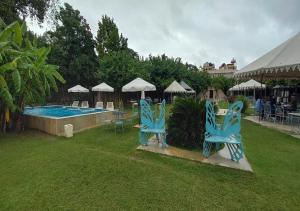two blue chairs and a swimming pool in a yard at Rampratap Palace by Fateh Collection in Udaipur