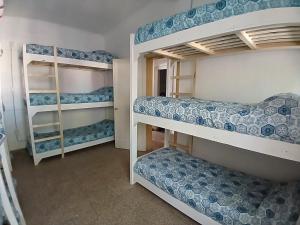a room with bunk beds with blue and white at Hostel San Rafael - Bed & Breakfast in San Rafael
