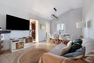 a living room with a couch and a flat screen tv at El apretadero in Icod de los Vinos