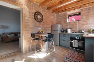 a kitchen with a table and a refrigerator in a room at El apretadero in Icod de los Vinos
