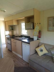 a small kitchen with a couch in a room at Rose Corner in Axminster