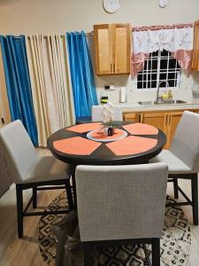 a kitchen with a table and chairs in a room at SG Apartment Complex (Apt #1) in Linstead