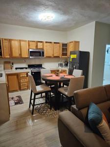 a kitchen with a table and chairs in a room at SG Apartment Complex (Apt #1) in Linstead