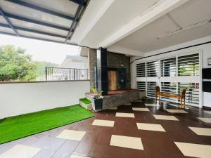 a room with a balcony with green grass at FREE Wi-fi 100mbps I Emerald Cove Rawang in Rawang