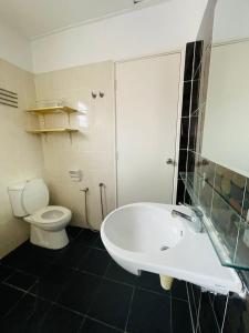 a bathroom with a white tub and a toilet at FREE Wi-fi 100mbps I Emerald Cove Rawang in Rawang +28 photos