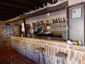 a bar with two stools in front of it at La casa de Aza in Haza