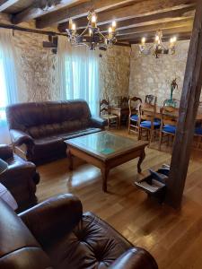 a living room with a leather couch and a table at La casa de Aza in Haza +37 photos