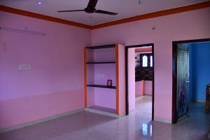 a pink room with a ceiling fan and a mirror at Arunachala Mountain View House in Tiruvannāmalai