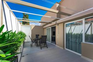 a balcony with a table and chairs on a house at BAL Apartments Adults Only in Arona