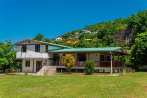 a house with a hill in the background at Maison de Lecointe in Dublanc