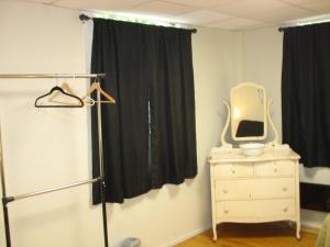 a bedroom with a dresser with a television on it at Art Gallery Hostel in Whitefield