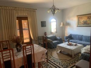 a living room with a couch and a table at Karitsa's Holiday Home in Karítsa