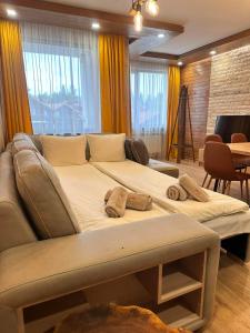a large bed with two pillows on it in a room at Alpine luxury two bed-two bathrooms apartment B25 in Borovets