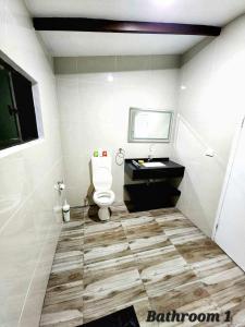 a bathroom with a toilet and a sink at Mstys Coastal Escape in Singatoka