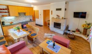 a living room with a table and a fireplace at Apartmány Skihouse Jasná in Demanovska Dolina