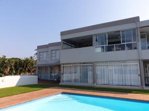 a house with a swimming pool in front of it at 19 Tontiki in Ballito