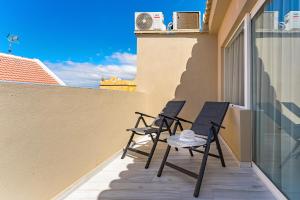 two chairs on the balcony of a building at BAL Apartments Adults Only in Arona
