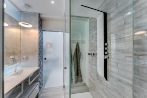 a bathroom with a glass shower and a sink at BAL Apartments Adults Only in Arona