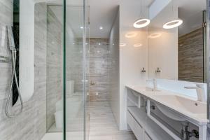 a bathroom with a glass shower and a sink at BAL Apartments Adults Only in Arona