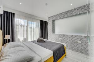 a bedroom with a bed and a large window at BAL Apartments Adults Only in Arona
