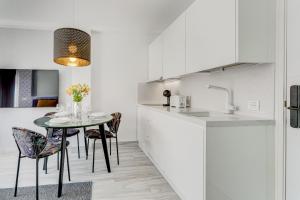 a kitchen and dining room with a table and chairs at BAL Apartments Adults Only in Arona
