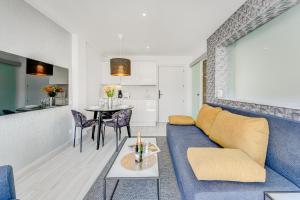 a living room with a blue couch and a table at BAL Apartments Adults Only in Arona