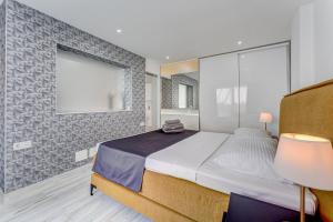a bedroom with a large bed and a large window at BAL Apartments Adults Only in Arona