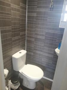 a bathroom with a white toilet and a sink at Camelot Seafront Hotel in Blackpool