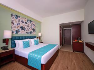 Postel nebo postele na pokoji v ubytování Daiwik Hotels Rameswaram