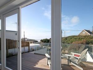 a balcony with a view of the ocean from a house at The Beach House in Wadebridge