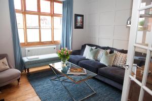 a living room with a couch and a glass table at Shrewsbury Townhouse - Free Parking in Shrewsbury