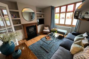 a living room with a couch and a mirror at Shrewsbury Townhouse - Free Parking in Shrewsbury
