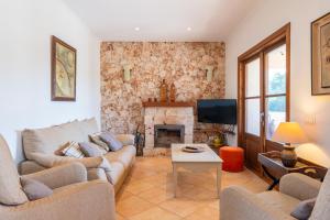a living room with a couch and a fireplace at Ca Na Capellana in Sineu