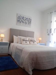 a bedroom with a bed with two pillows on it at Inviting 2-Bed Apartment in Nazare in Nazaré