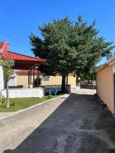 a street with a tree and a pavilion and a tree at Dimitra's House in Gómfoi