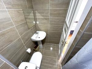 a bathroom with a sink and a toilet at Meydan Pansiyon Uskudar in Istanbul