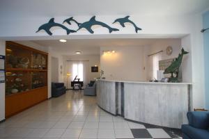 a lobby with a bar with dolphins on the wall at Dolphin Hotel in Skopelos Town