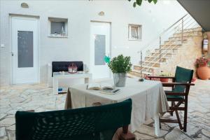 a table and chairs in a living room at Dimitra Apartments in Kandia
