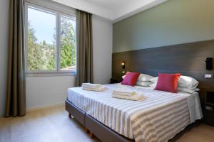 a bedroom with a large bed with a large window at AGRITURISMO TERRA VOLONTERI in Montecatini Terme