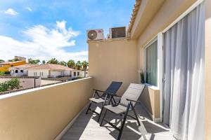 a balcony with two chairs and a speaker at BAL Apartments Adults Only in Arona