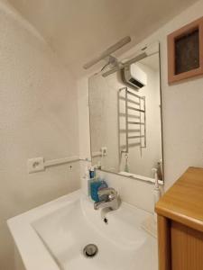 a white bathroom with a sink and a mirror at Chambre atypique : La Grotte in Bez-et-Esparon