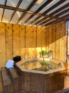 a large tub in a room with a wooden wall at Срібний Водограй in Polyana