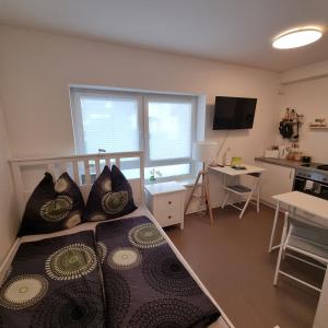 a room with a bed and a kitchen with a table at Hafenstraße Kassel in Kassel