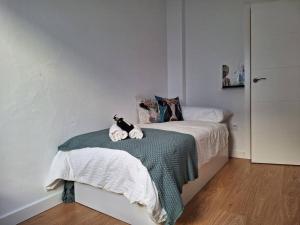 Un dormitorio con una cama con dos gatos. en Apartamento Plaza España de Luque, en Luque